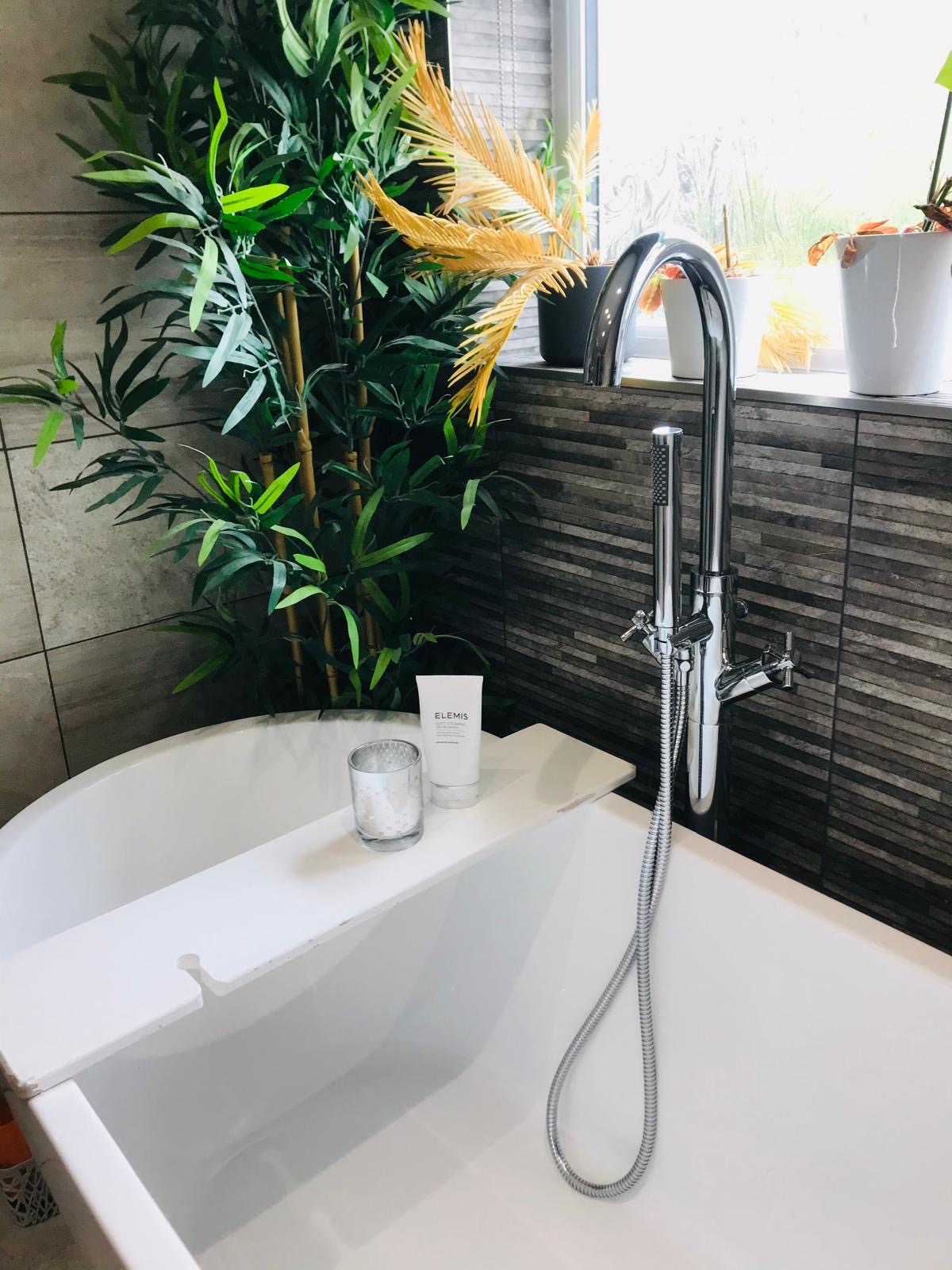 Polished chrome bath tap and freestanding bath
